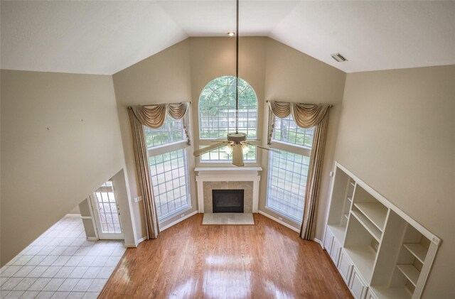 3718 W Pine Brook Way, Houston, TX 77059 - unfurnished living room with ceiling fan, high vaulted ceiling, a fireplace with flush hearth, and wood finished floors