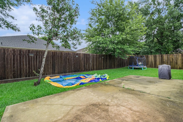 30110 Saw Oaks, Magnolia, TX 77355 - fenced backyard featuring a trampoline and a patio area
