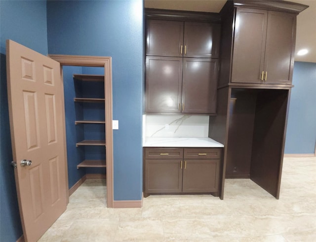 13326 Joliet St, Houston, TX 77015 - kitchen featuring light countertops, dark brown cabinets, and decorative backsplash
