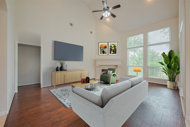 19339 Oxford Haven Dr, Cypress, TX 77433 - living room with ceiling fan, healthy amount of natural light, dark wood-style flooring, high vaulted ceiling, and a fireplace
