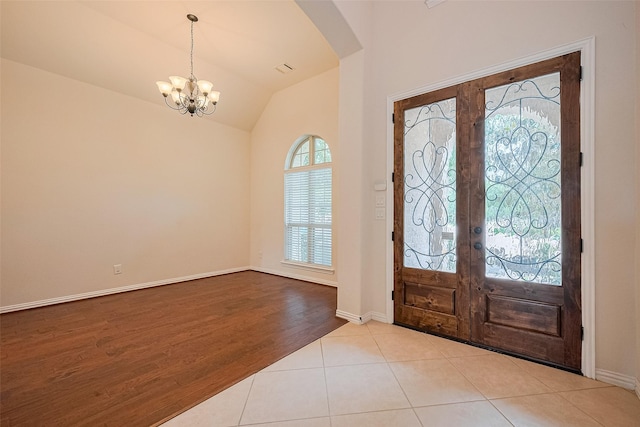 19339 Oxford Haven Dr, Cypress, TX 77433 - entrance foyer featuring french doors, arched walkways, a chandelier, lofted ceiling, and tile patterned floors