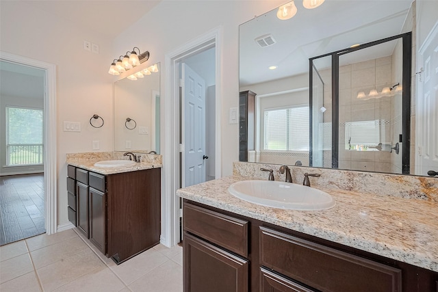 19339 Oxford Haven Dr, Cypress, TX 77433 - bathroom with plenty of natural light, two vanities, a shower stall, and tile patterned flooring