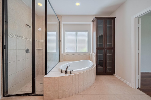 19339 Oxford Haven Dr, Cypress, TX 77433 - bathroom featuring a garden tub, a stall shower, tile patterned floors, and recessed lighting
