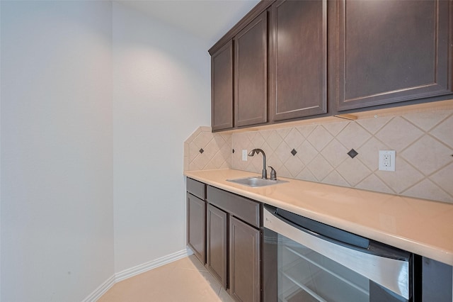 19339 Oxford Haven Dr, Cypress, TX 77433 - kitchen with tasteful backsplash, dark brown cabinetry, light countertops, dishwashing machine, and light tile patterned floors