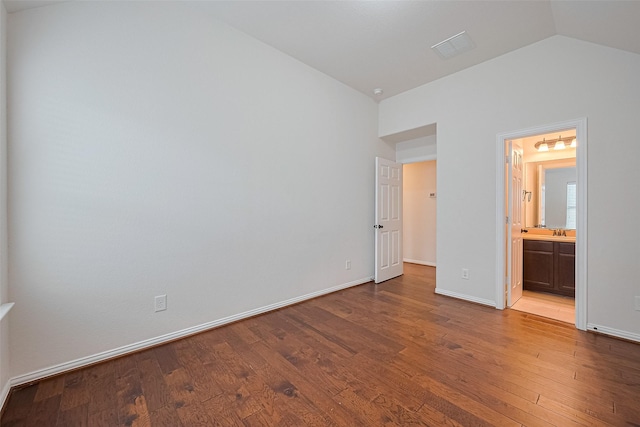 19339 Oxford Haven Dr, Cypress, TX 77433 - unfurnished bedroom with lofted ceiling, wood finished floors, and connected bathroom