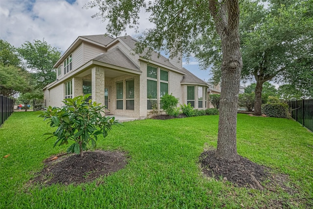 19339 Oxford Haven Dr, Cypress, TX 77433 - back of house featuring brick siding, a fenced backyard, a patio area, and roof with shingles