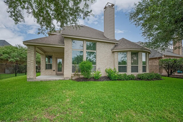 19339 Oxford Haven Dr, Cypress, TX 77433 - rear view of property with a patio area, brick siding, a fenced backyard, a chimney, and roof with shingles