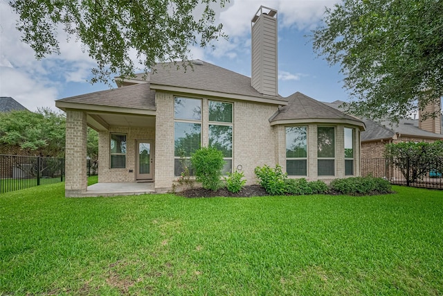 19339 Oxford Haven Dr, Cypress, TX 77433 - rear view of house featuring a patio area, brick siding, a chimney, and a shingled roof