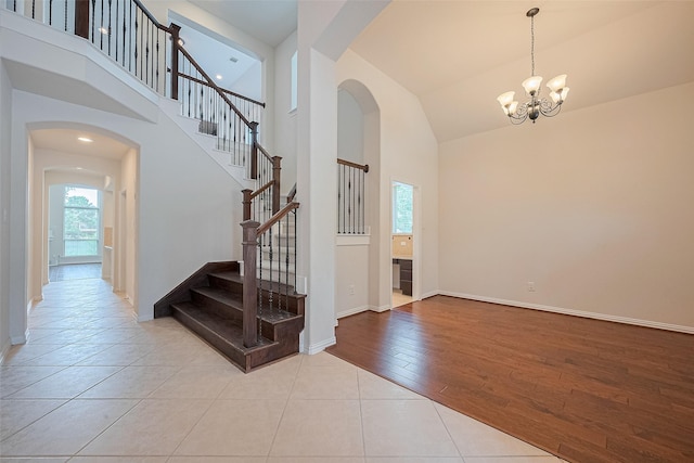 19339 Oxford Haven Dr, Cypress, TX 77433 - staircase featuring healthy amount of natural light, arched walkways, high vaulted ceiling, and a chandelier