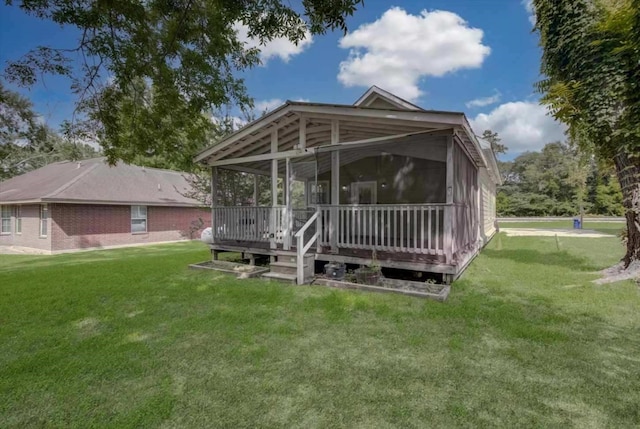 610 S Railroad Ave, Shepherd, TX 77371 - rear view of property featuring a sunroom and a yard