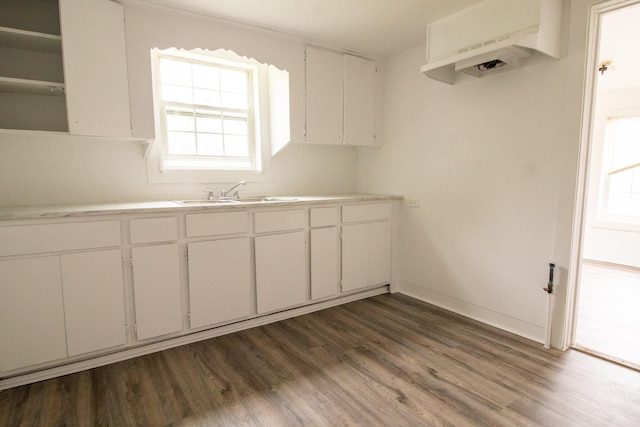 4918 Leffingwell St, Houston, TX 77026 - kitchen with dark wood finished floors, white cabinets, light countertops, open shelves, and ornamental molding