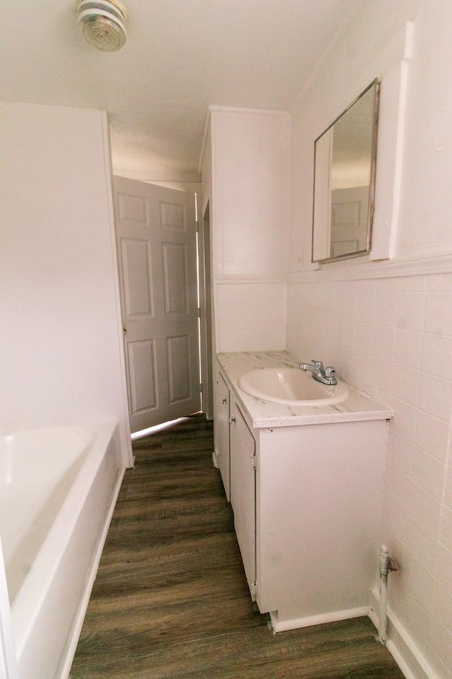 4918 Leffingwell St, Houston, TX 77026 - full bathroom featuring vanity, wood finished floors, a bathtub, and tile walls