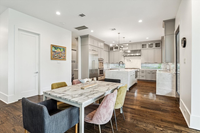 1010 Waltway Dr, Houston, TX 77008 - dining area featuring dark wood-type flooring and recessed lighting