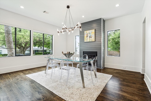1010 Waltway Dr, Houston, TX 77008 - dining space with a chandelier, a large fireplace, recessed lighting, and dark wood-type flooring