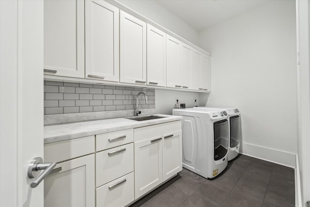 1010 Waltway Dr, Houston, TX 77008 - washroom featuring cabinet space, separate washer and dryer, and dark tile patterned flooring