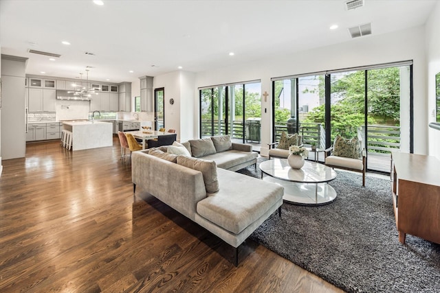 1010 Waltway Dr, Houston, TX 77008 - living area featuring dark wood-type flooring, plenty of natural light, recessed lighting, and a chandelier