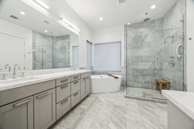 1010 Waltway Dr, Houston, TX 77008 - full bath with a shower stall, double vanity, a soaking tub, marble finish floors, and recessed lighting