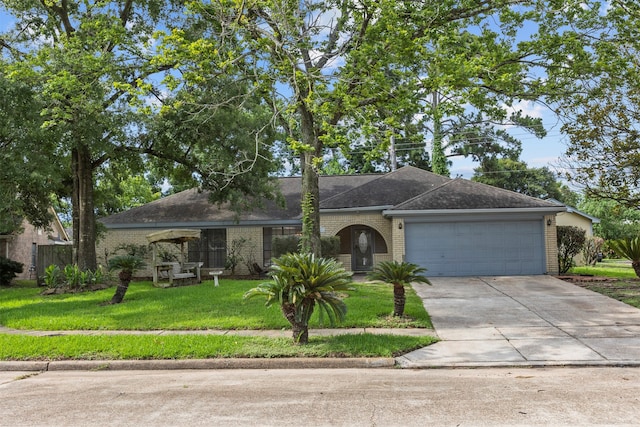 14202 Double Pine Dr, Houston, TX 77015 - ranch-style house with brick siding, a garage, driveway, and a front yard
