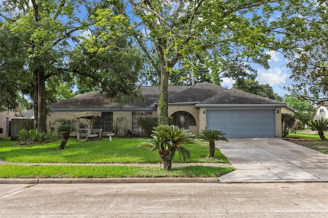 14202 Double Pine Dr, Houston, TX 77015 - single story home featuring brick siding, an attached garage, driveway, a front yard, and roof with shingles