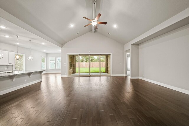 10519 Lantana Pass, Missouri City, TX 77459 - unfurnished living room featuring a ceiling fan, dark wood finished floors, beamed ceiling, recessed lighting, and high vaulted ceiling
