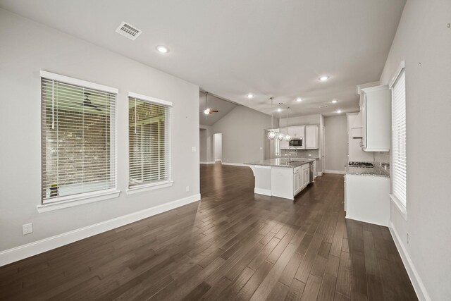 10519 Lantana Pass, Missouri City, TX 77459 - kitchen featuring white cabinetry, light stone counters, hanging light fixtures, a center island with sink, and recessed lighting