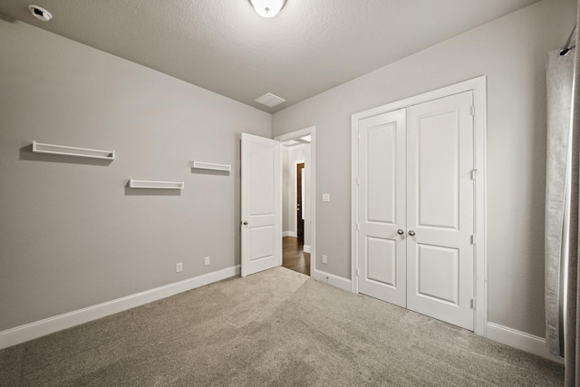 10519 Lantana Pass, Missouri City, TX 77459 - unfurnished bedroom with carpet floors, a closet, and a textured ceiling