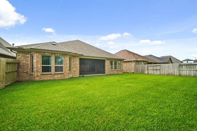 10519 Lantana Pass, Missouri City, TX 77459 - back of property featuring a fenced backyard, brick siding, and a shingled roof