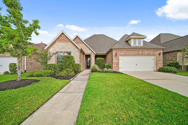 10519 Lantana Pass, Missouri City, TX 77459 - view of front of property featuring a front yard, brick siding, a garage, concrete driveway, and roof with shingles