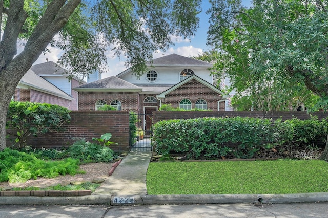 4723 Cashel Castle Dr, Houston, TX 77069 - view of front of property with a fenced front yard, a gate, brick siding, and a shingled roof