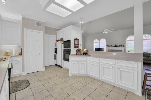 4723 Cashel Castle Dr, Houston, TX 77069 - kitchen with black appliances, ceiling fan, light tile patterned flooring, lofted ceiling, and white cabinetry