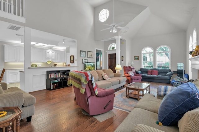 4723 Cashel Castle Dr, Houston, TX 77069 - living area featuring a towering ceiling, a ceiling fan, hardwood / wood-style flooring, ornate columns, and a fireplace