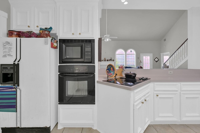 4723 Cashel Castle Dr, Houston, TX 77069 - kitchen with black appliances, light tile patterned floors, ceiling fan, and white cabinetry