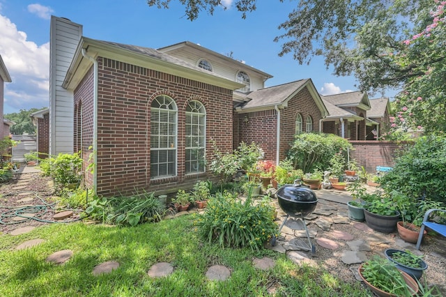 4723 Cashel Castle Dr, Houston, TX 77069 - back of house with brick siding, a chimney, and a patio