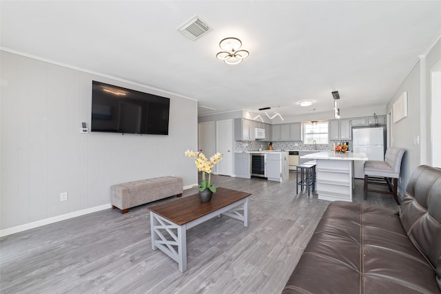 610 Seashell Dr, Freeport, TX 77541 - living area with beverage cooler and light wood-style flooring