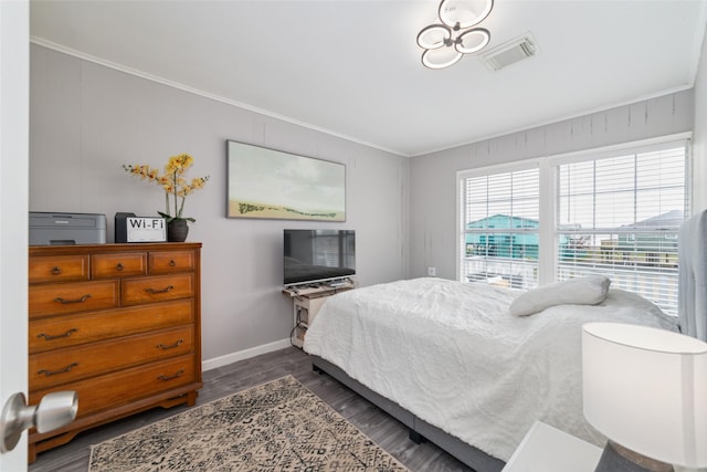 610 Seashell Dr, Freeport, TX 77541 - bedroom featuring crown molding and dark wood-style flooring