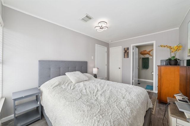 610 Seashell Dr, Freeport, TX 77541 - bedroom with ornamental molding, wood finished floors, and ensuite bath