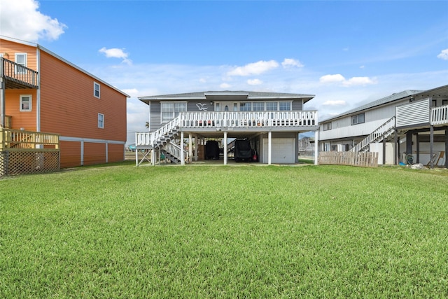 610 Seashell Dr, Freeport, TX 77541 - back of house featuring stairs, an attached garage, a lawn, and a deck