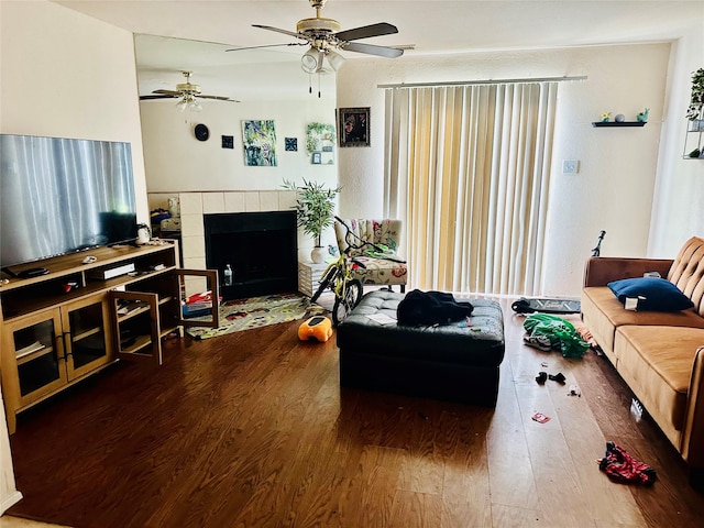 12656 Windsor Village Dr Unit 2656, Houston, TX 77071 - living area with wood finished floors, a ceiling fan, and a tiled fireplace
