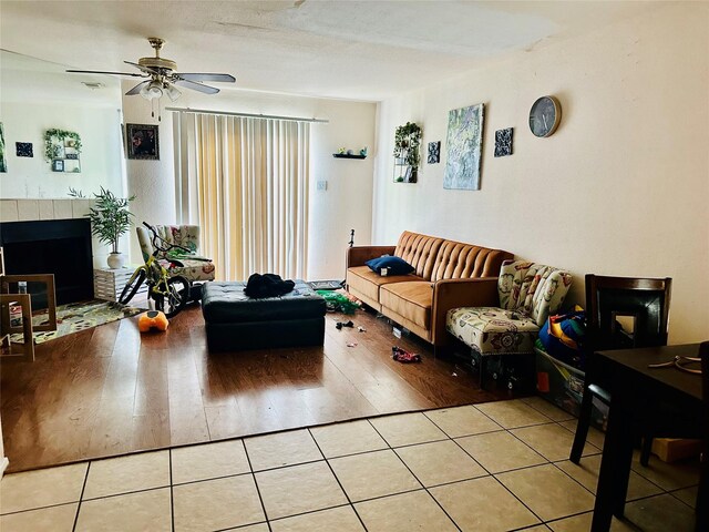 12656 Windsor Village Dr Unit 2656, Houston, TX 77071 - living area with ceiling fan, wood finished floors, and a tile fireplace