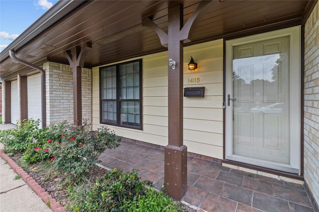 14115 Lantern Ln, Houston, TX 77015 - doorway to property with covered porch and a garage