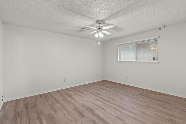 14115 Lantern Ln, Houston, TX 77015 - empty room featuring a ceiling fan, light wood-style floors, and a textured ceiling