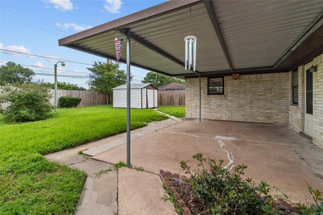 14115 Lantern Ln, Houston, TX 77015 - view of patio featuring a storage unit and a carport