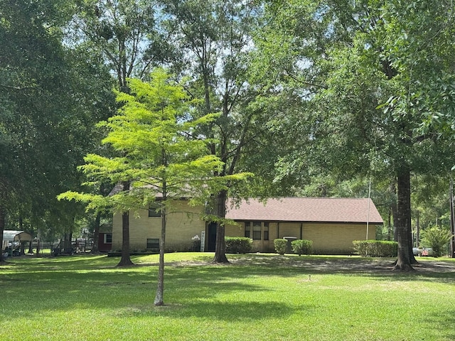 147 County Road 4772, Warren, TX 77664 - view of property hidden behind natural elements featuring a front yard