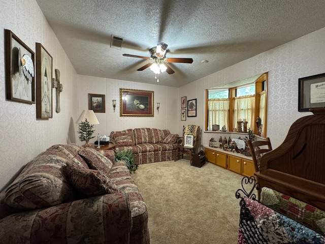 147 County Road 4772, Warren, TX 77664 - living area featuring a ceiling fan, carpet floors, a textured ceiling, and wallpapered walls