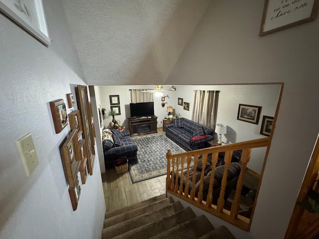 147 County Road 4772, Warren, TX 77664 - stairway featuring hardwood / wood-style floors, vaulted ceiling, and a textured ceiling