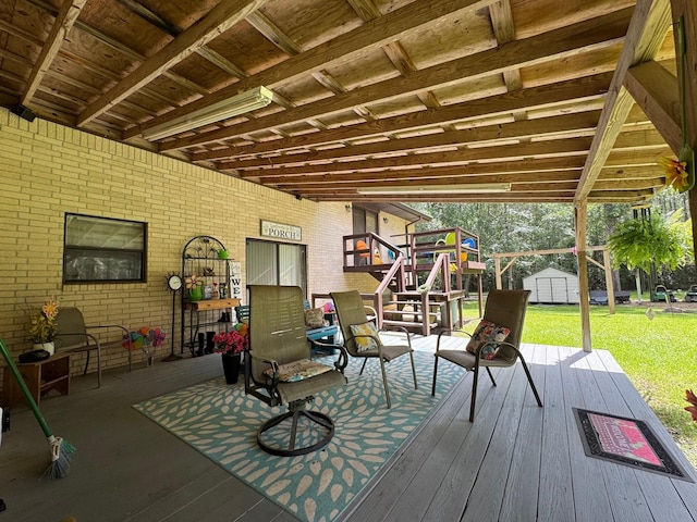 147 County Road 4772, Warren, TX 77664 - wooden terrace featuring a storage unit, stairway, and a yard