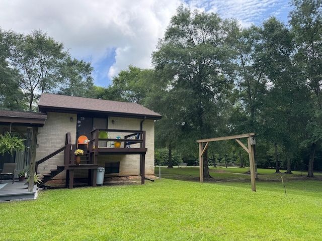 147 County Road 4772, Warren, TX 77664 - view of green lawn with a deck and stairway