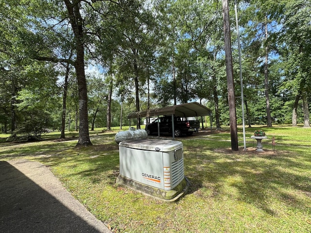 147 County Road 4772, Warren, TX 77664 - view of grassy yard with a carport and view of wooded area