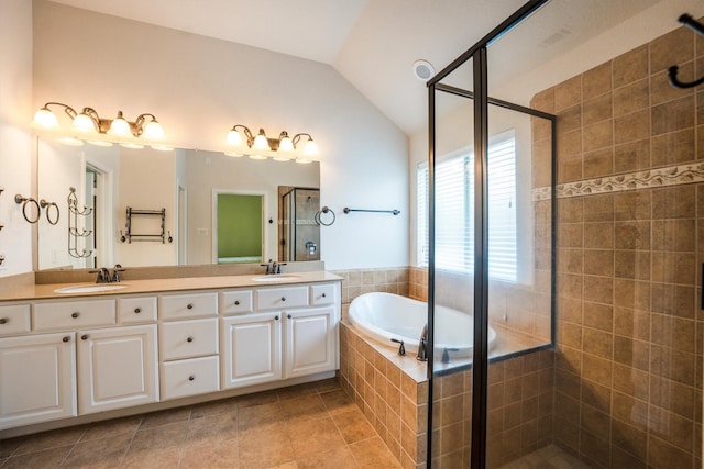 18419 W Willow Oak Bend Dr, Cypress, TX 77433 - bathroom featuring a stall shower, double vanity, lofted ceiling, a bath, and tile patterned flooring