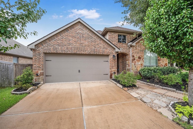 18419 W Willow Oak Bend Dr, Cypress, TX 77433 - view of front facade with brick siding, concrete driveway, a garage, and stone siding